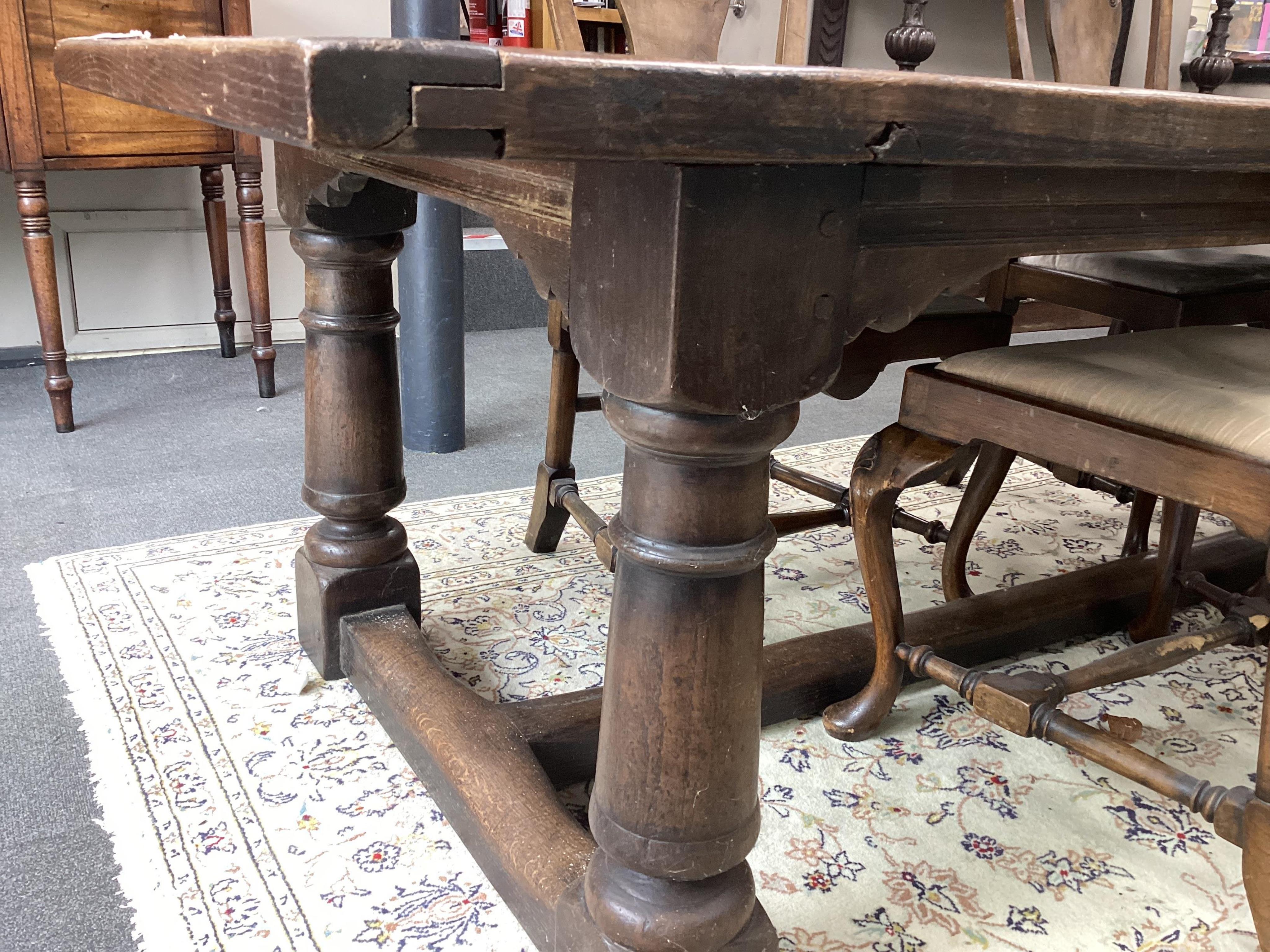 An 18th century style rectangular oak refectory dining table, width 243cm, depth 90cm, height 72cm. Condition - fair